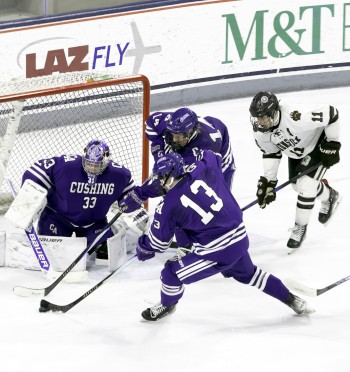 Cushing freshman goaltender Mason Raycroft watches as teammate Axel Favreau, a senior forward who had 3 assists in the game, gets back on defense and 