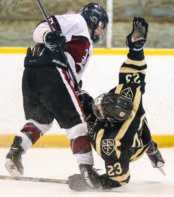 Loomis sophomore F Eric Esposito bowls over Westminster's 6'4" d-man Will Brophy.