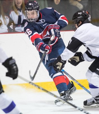 Lawrence sophomore F Sam Colangelo is hemmed in by a pair of Cushing defenders.