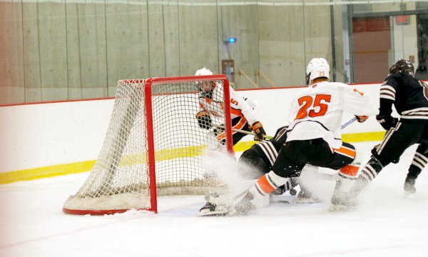 KUA senior F Jackson Davies is stymied by Brunswick junior G Zai Ferraro in KUA's 3-2 win over Brunswick at the Exeter Invitational on Sun. Dec. 7